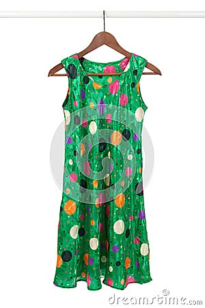 Bright green dress on a wooden hanger Stock Photo