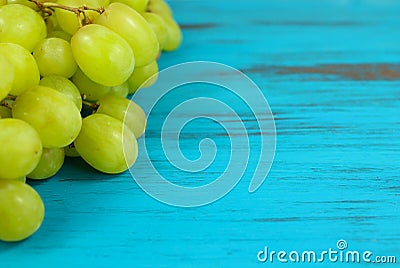 Bright green grapes on a turquoise distressed wood background Stock Photo