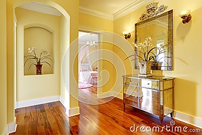 Bright hallway with shiny cabinet and flowers Stock Photo