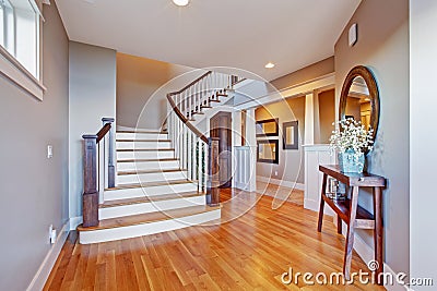 Bright hallway with wooden staircase Stock Photo