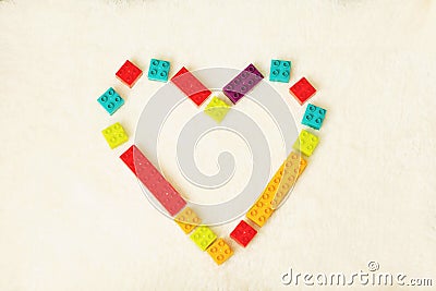 Bright heart made of colorful plastic bricks on white background. Early learning. Developing toys Stock Photo