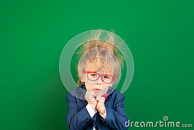 Bright idea! Confusion child student against green chalkboard Stock Photo