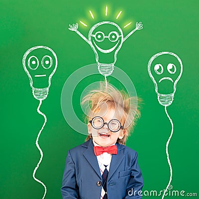 Bright idea! Happy geek against green chalkboard Stock Photo