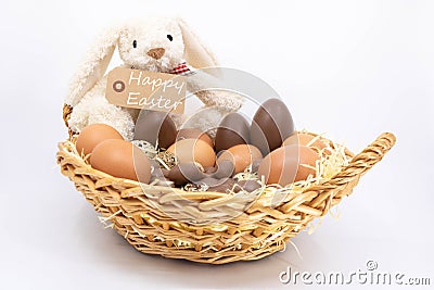 Easter bunny and the text Happy Easter in a basket of eggs Stock Photo