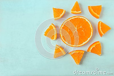 Bright juicy orange slices in the shape of a sun on a light back Stock Photo