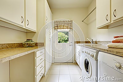 Bright laundry room with white cabinets Stock Photo