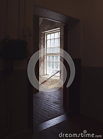 Bright light from stairwell window, seen from a dark doorway. Stock Photo
