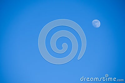 Bright little full blue moon against a blue sky in the afternoon, background, copyspace Stock Photo