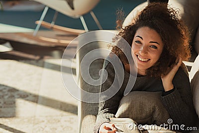 Bright living room, couch, relaxed reading, head propped, leisur Stock Photo