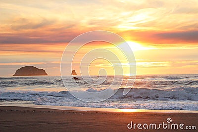 Bright luminous early sunset over Rocky outcrops on Oregon Coast Stock Photo