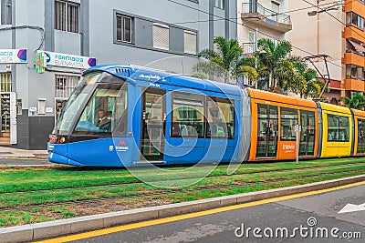 Bright modern moving tram with multicolor carriages on the street of Santa Cruz Editorial Stock Photo