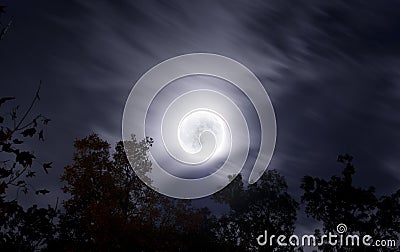 Bright moon on fall night with clouds and foliage Stock Photo