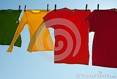 Bright multi-colored clothes drying in the wind Stock Photo