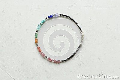 Bright multicolored bracelet. Ruby, coral, carnelian, citrine, emerald, apatite, amazonite, turquoise, lapis lazuli, tanzanite, Stock Photo