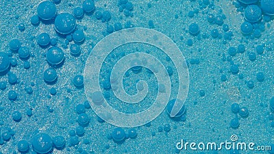 Bright neon blue bubbles oil and ink, acrylic paint moving close-up, wallpaper background Stock Photo