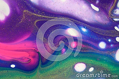 Neon pink and glitter gold swirl through purple and blue in this abstract acrylic pour painting for backgrounds. Stock Photo