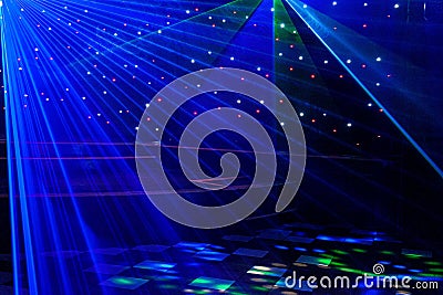 Bright nightclub purple, white, blue laser lights cutting through smoke machine smoke making light and rainbow patterns Stock Photo