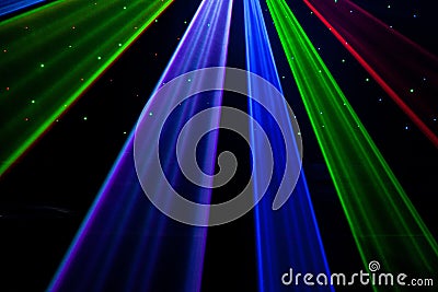 Bright nightclub red, green, purple, white, pink, blue laser lights cutting through smoke machine smoke making light patterns Stock Photo