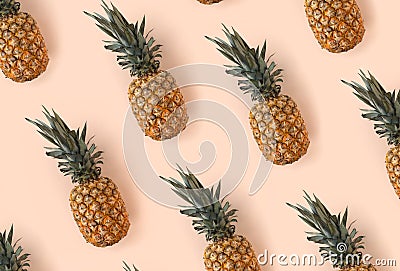 Bright pattern of many pineapples on a trendy soft beige pink background Stock Photo