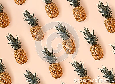 Bright pattern of many pineapples on a trendy soft beige pink background Stock Photo