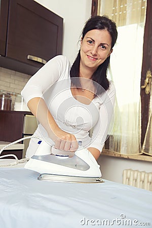 Bright picture of lovely housewife with iron Stock Photo