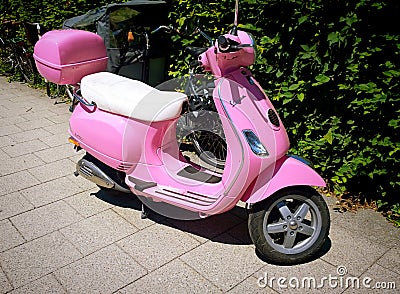 Bright pink vintage Vespa, lateral view Editorial Stock Photo
