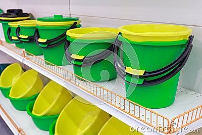 Bright plastic buckets and bowls on the counter Stock Photo