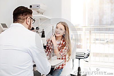 Bright positive patient sitting at ophthalmologists office Stock Photo