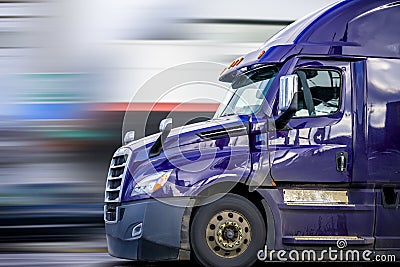 Bright Purple Bonnet Semi Truck Tractor with Reflection Driving on the Road for Delivery Commercial Cargo Stock Photo