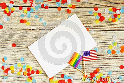 Bright rainbow gay flag on wooden background, paper confetti top view with space for text, mocup, copy space. LGBT community. Stock Photo