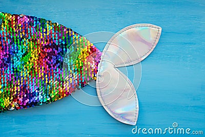 Bright rainbow mermaid tail on a blue background Stock Photo