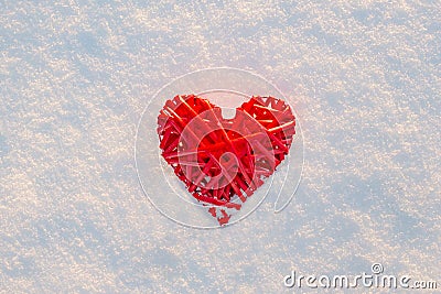 Bright red heart lies on the white snow Stock Photo