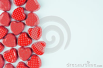 Bright red hearts on mint pastel paper background as decorative border with copy space. Valentine`s day youth design concept art. Stock Photo