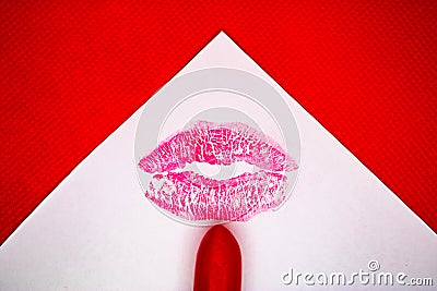 Kiss mark and the red lipstick on the white paper with the red background - Image Stock Photo
