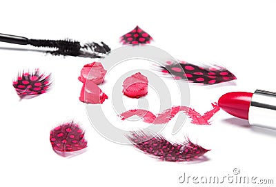 Bright red lipstick with black mascara and mottled feathers Stock Photo
