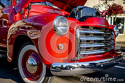 Bright red vintage retro truck with an open hood standing at an exhibition on a street of a provincial town Editorial Stock Photo