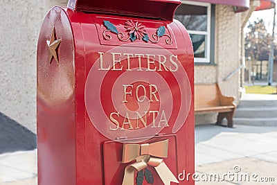 Bright shiny red mailbox for children to mail letters to Santa Claus Stock Photo