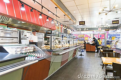 Bright shot of burgers, donuts and sandwiches in a bakery or shop glass counter. Editorial Stock Photo