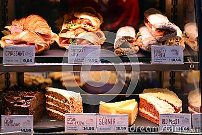 Bright shot of burgers, donuts and sandwiches in a Starbucks Coffee. Shiny showcase of baked fastfood with prices. Editorial Stock Photo