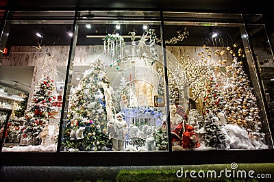 Bright showcase of shop with Christmas gifts and tree Editorial Stock Photo