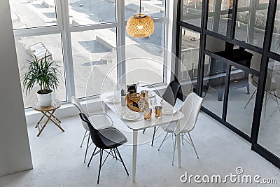 Bright spacious black and white dining room with a big window Stock Photo