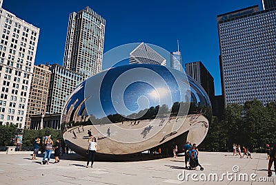 Bright summer day at Millennium Park in Chicago, Illinois with the famous Bean sculpture in the back Editorial Stock Photo