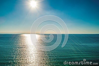 Bright sun rays over calm sea water. Stock Photo