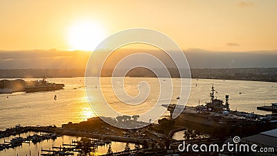 Bright sun sets over the USS Midway on San Diego Bay in Southern California Editorial Stock Photo