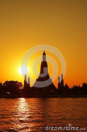 Bright Sun Shining over the Silhouette of Temple of Dawn or Wat Arun, Bangkok of Thailand Stock Photo