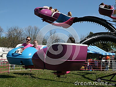 Thrill-seekers enjoy a ride at a local traveling show Editorial Stock Photo