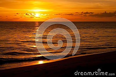 Bright sunrise in early morning with sand beach Stock Photo