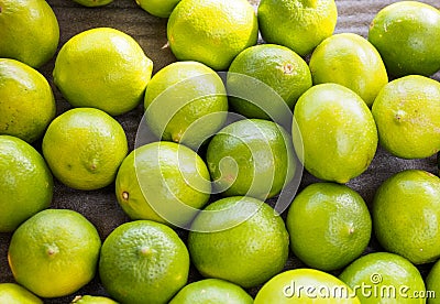 Bright vibrant green bunch of limes on a dark background Stock Photo