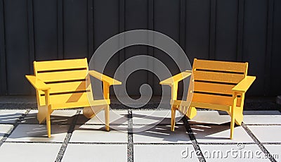 Bright Wooden Chairs on Large Stone Pavers, Ultra Modern or Mid Century Modern Stock Photo