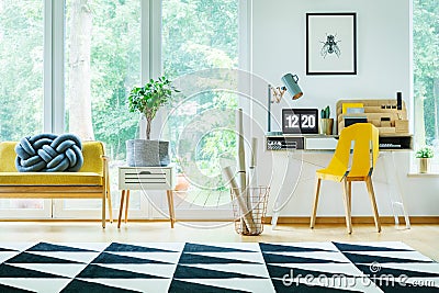 Bright workspace with yellow chair Stock Photo
